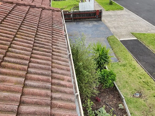 Before and after of pressure washed cleaned gutters